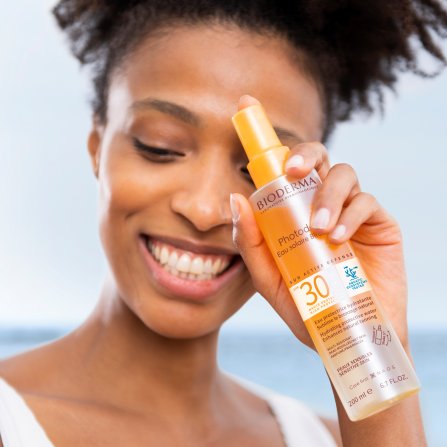 Women with black skin using Photoderm SPF30 water-based Sunscreen