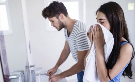 Couple in a bathroom - Woman dry her face